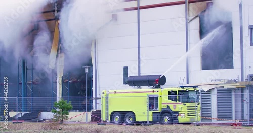 Firetruck trying to get control over a fire in industrial building