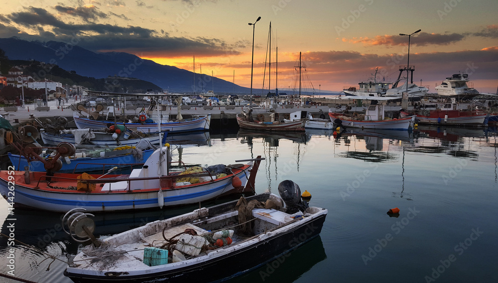 Fishing boats in the harbour at sunset