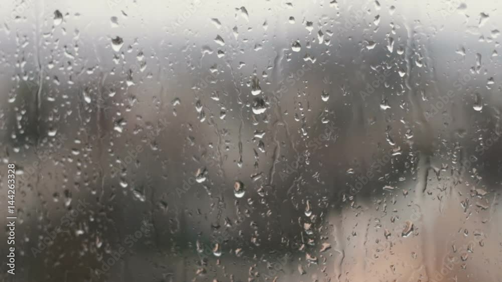 Rain drops on the glass in the spring afternoon Rain drops on the glass in the spring afternoon