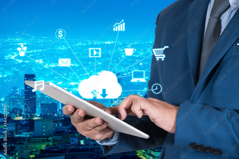 businessmen in blue suite using internet of things on mobile or tablet with night modern city background businessmen in blue suite using internet of things on mobile or tablet with night modern city background