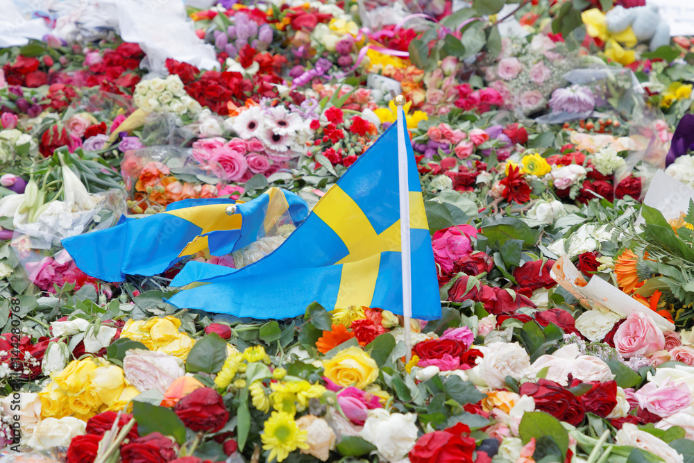 Fototapeta premium Flowers and swedish flag from people paying respect to the victims in the terror attack in Stockholm