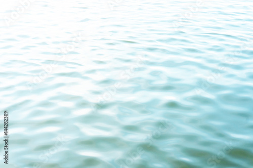 Light background. Ripples on the surface of the water. A small wave of water.