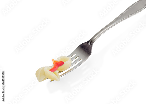 Cooked seashell shaped pasta on the fork on light background