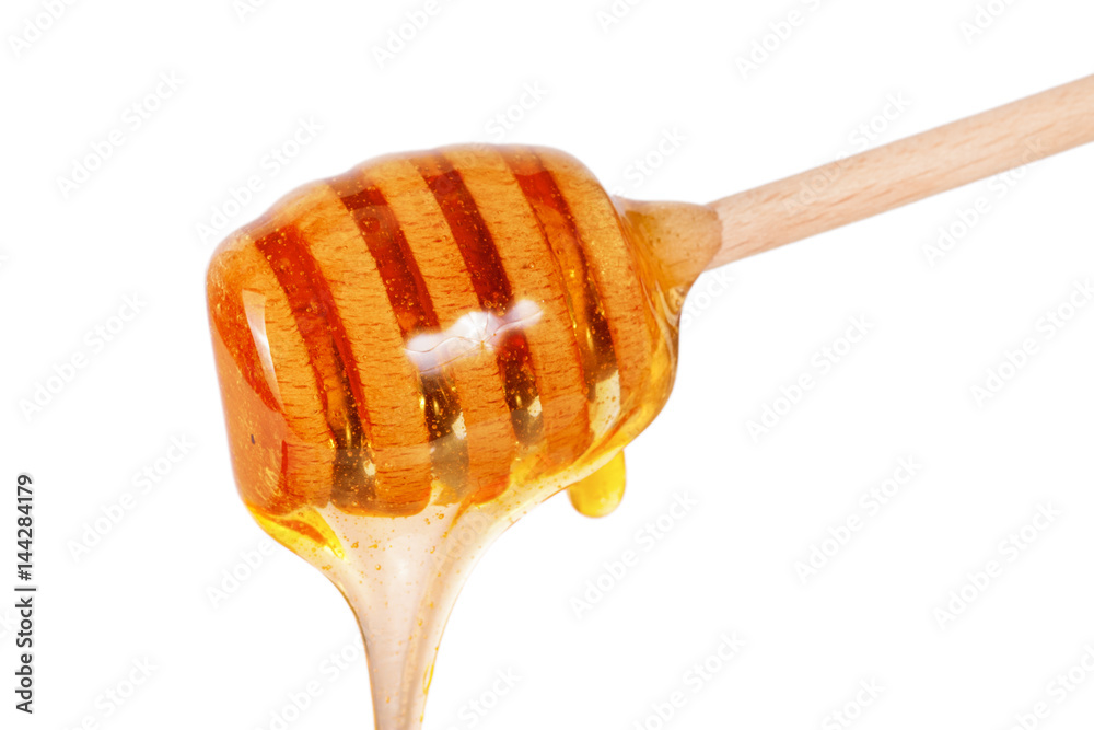 Honey stick with flowing honey isolated on white background