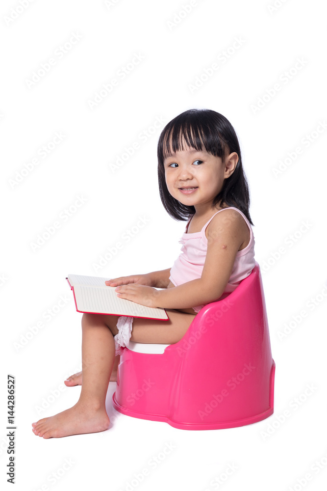 Asian chinese little girl sitting on chamberpot with book Stock Photo ...