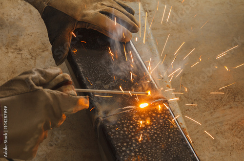 Shield metal arc welding joint steel in manufacturing work shop.