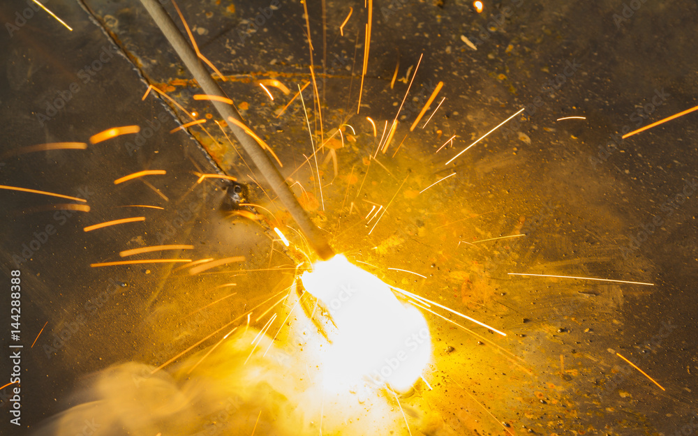 SMAW – Shielded matal arc welging and welding flame at spark  point. - obrazy, fototapety, plakaty 
