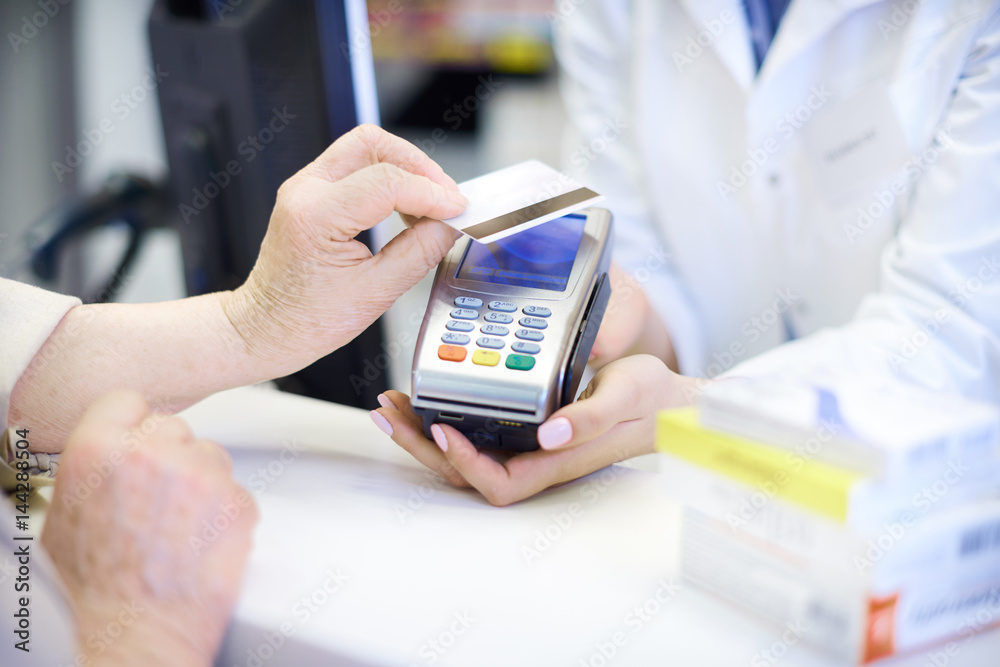 Close up of contactless payment at pharmacy .