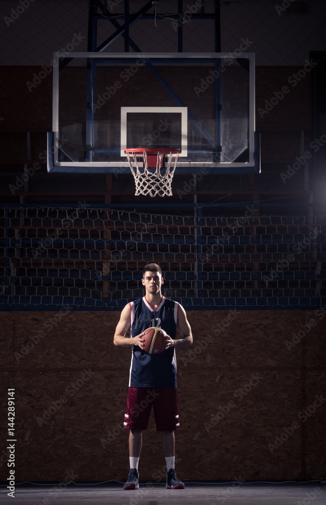 Naklejka premium basketball player, holding ball, indoors basketball court
