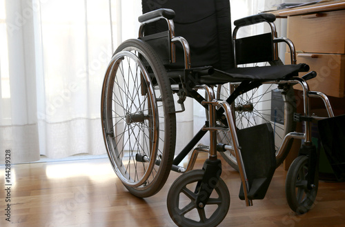 wheelchairs to disabled people in a bedroom photo