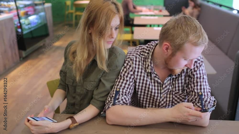 Angry couple, each with their phones Angry couple, each with their phones