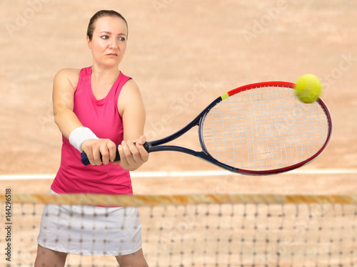 woman swatting the ball the tennis © cunaplus
