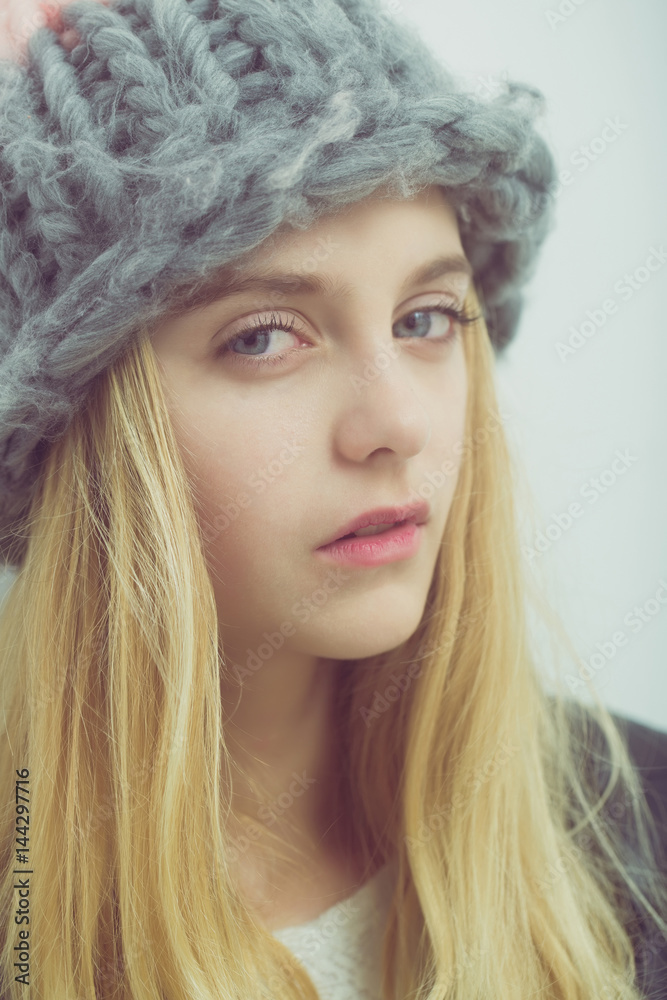 Pretty young girl with blond hair in fashionable hat Pretty young girl with blond hair in fashionable hat