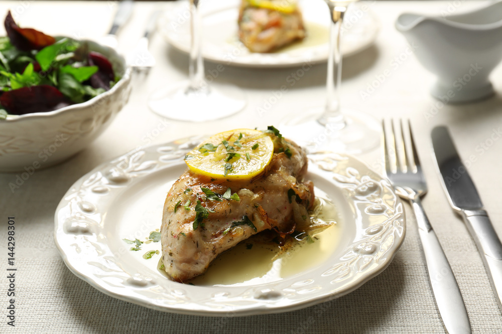 Plate with delicious chicken breast on served table Plate with delicious chicken breast on served table