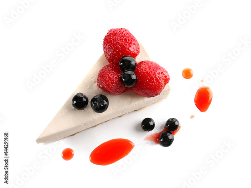 Delicious cheesecake slice with berries on white background