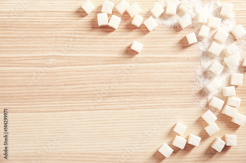 Sugar cubes on wooden background