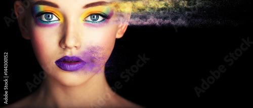 Fashion model girl portrait with colorful powder make up. Beauty woman with bright color makeup. Close-up of Vogue style lady face, Abstract colourful make-up, Art design. Black background. copy space