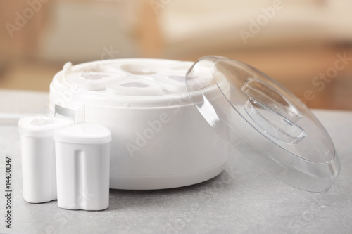 Modern yogurt maker on kitchen table