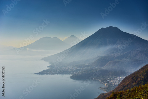 Highlands with volcanoes at Lake Atitlan in Guatemala / Foggy morning at lake in Guatemala in the morning hours