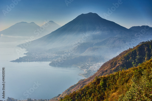 Highlands with volcanoes at Lake Atitlan in Guatemala   Foggy morning at lake in Guatemala in the morning hours