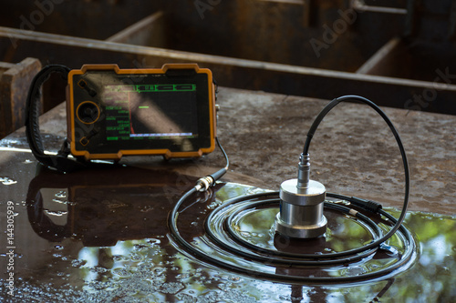 Ultrasonic test to detect imperfection or defect of steel plate in Workshop, NDT Inspection. photo