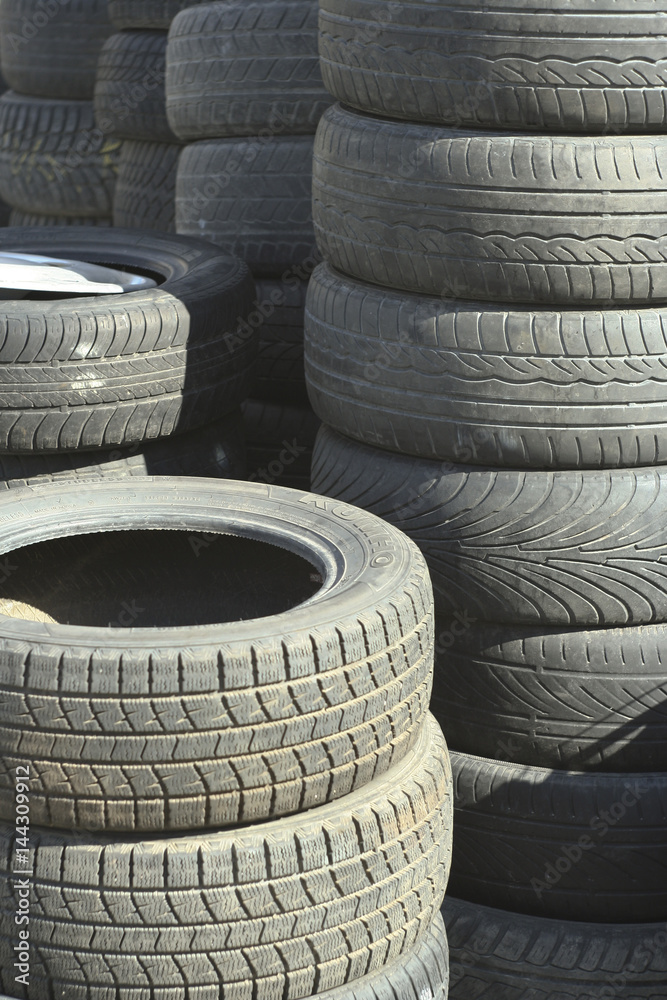 Pile of tires and wheels for rubber. Closeup for design work Pile of tires and wheels for rubber. Closeup for design work