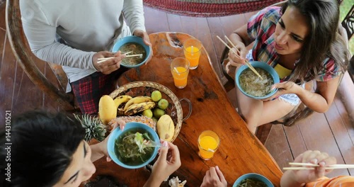People Eating Delicious Noodles Soup Asian Food, Friends Group Feed Each Other Sit At Table Top Angle View Slow Motion 60