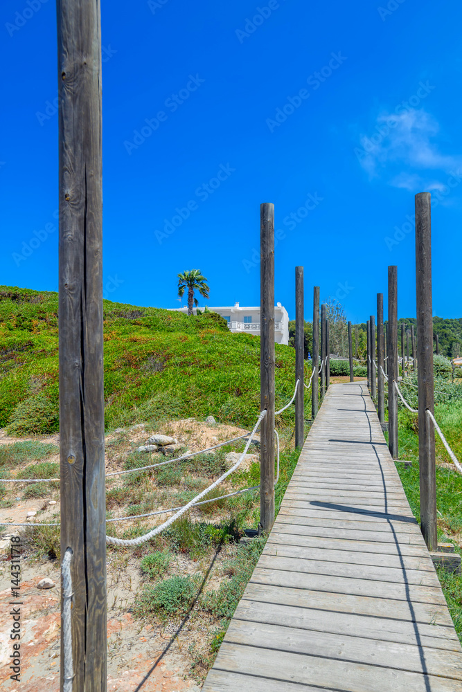 Wooden path to Playa de Son Bou Beach at Menorca
