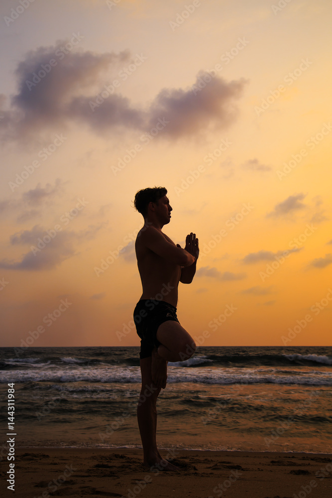 Athletic man doing sports on the beach.