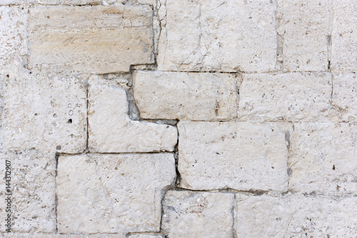 Detail of an antique white stone wall, background, texture