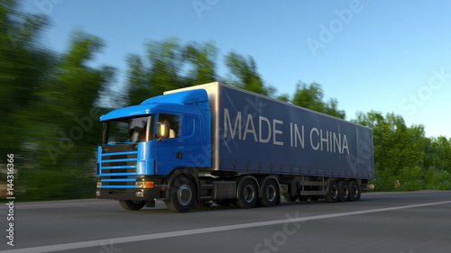Speeding freight semi truck with MADE IN CHINA caption on the trailer. Road cargo transportation. 3D rendering © Alexey Novikov