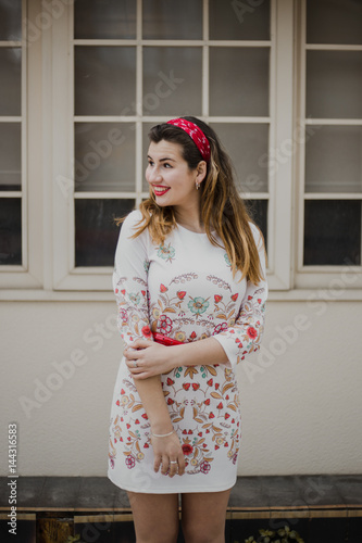 Very happy Young woman standing with vintage dress outside. Lifestyle