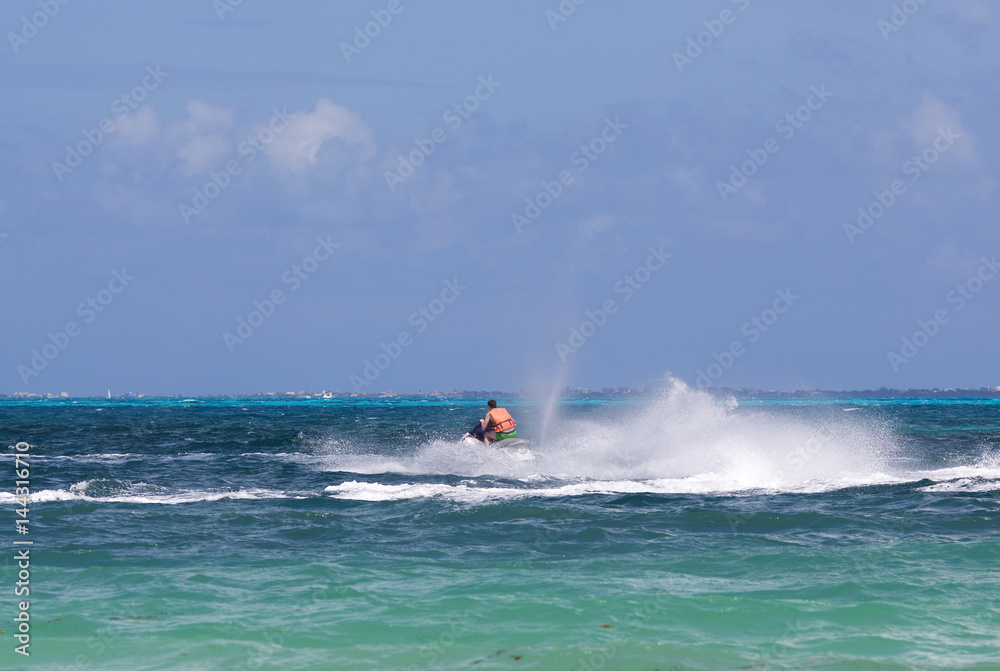 Man driving a jet ski. Water splashing. Man driving a jet ski. Water splashing.