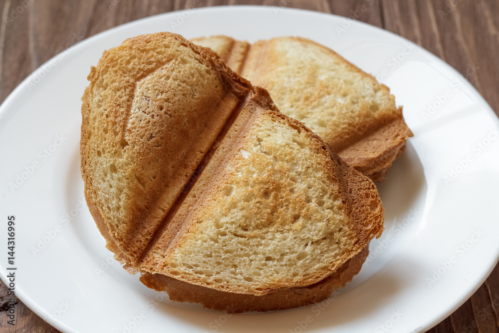 Baked bread toast on white plate