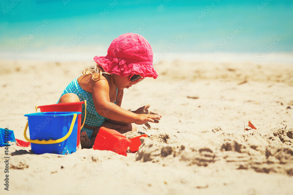 cute little girl play with sand on beach cute little girl play with sand on beach
