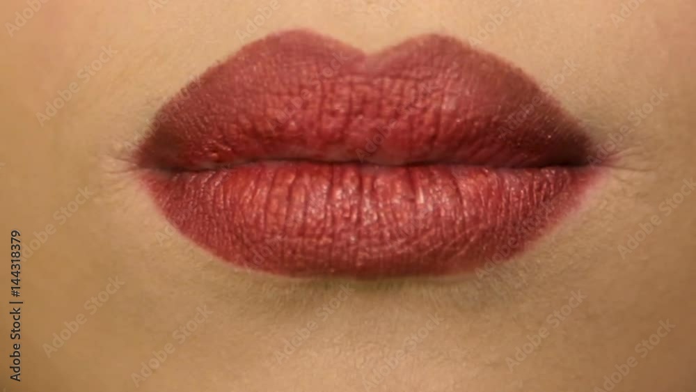 The girl sexually licks lips with red lipstick.Full hd video