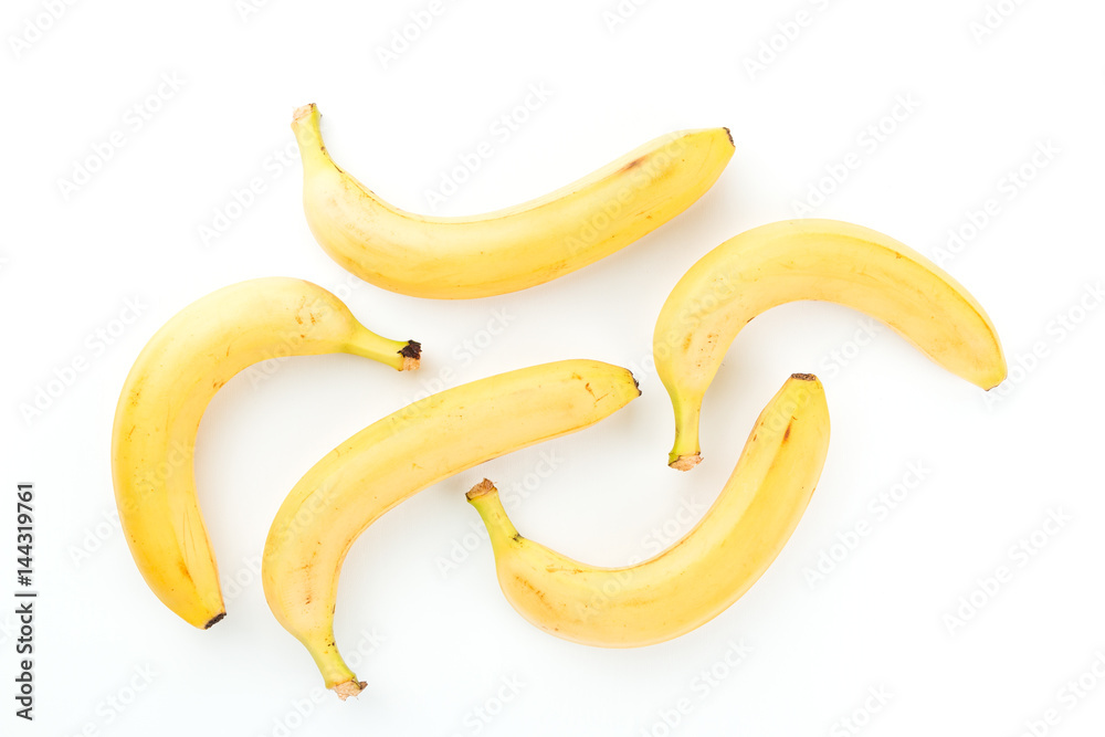 Several yellow ripe bananas from the tropics on a white background with place for text