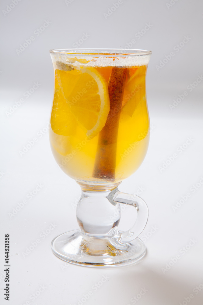 White mulled wine with spices, apple and orange on white background White mulled wine with spices, apple and orange on white background