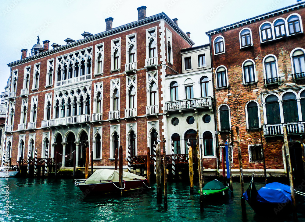 Facades of historical houses and gondolas on the Grand Canal. Venice, Italy