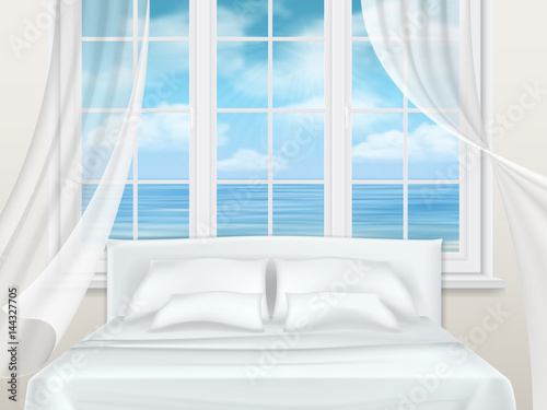 Bed near window with a view of the seascape. Bedroom in the apartment building or hotel room.