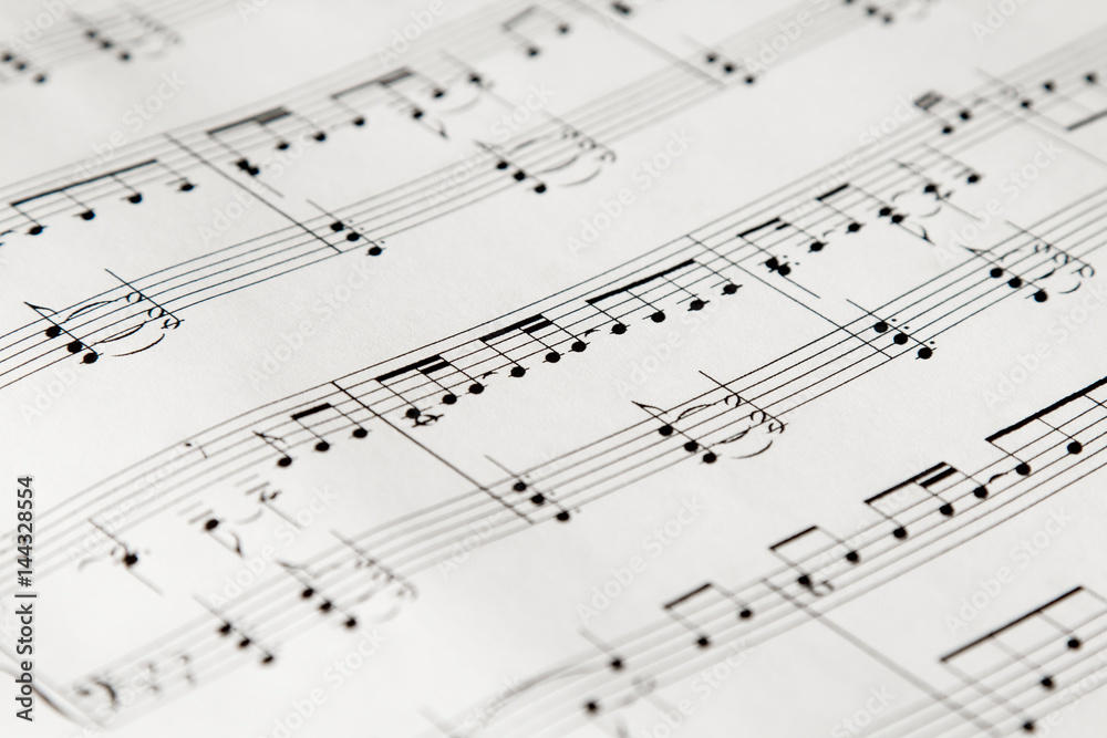 music-noteson white paper closeup perspective music-noteson white paper closeup perspective