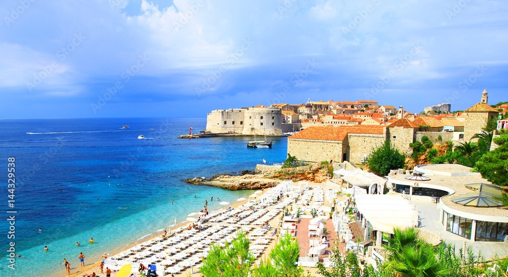 Tourists enjoying on sandy beach Banje, near Dubrovnik old town in Croatia