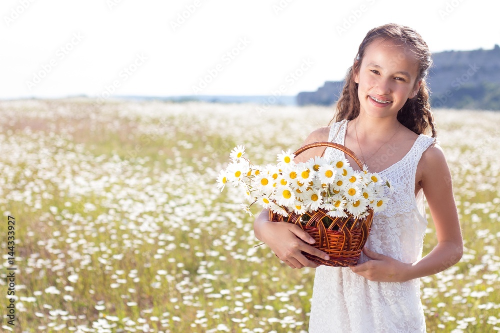 Happy girl walking in a field. Girl resting in a field of chamomile. Girl gathers daisies. Warm spring. Happy girl walking in a field. Girl resting in a field of chamomile. Girl gathers daisies. Warm spring.