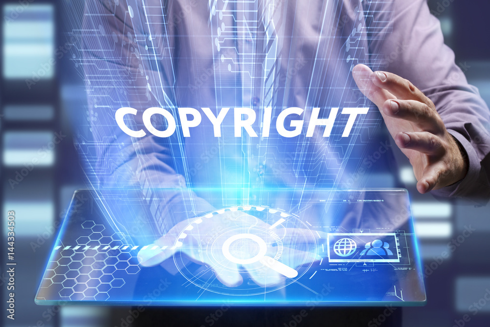 Business, Technology, Internet and network concept. Young businessman working on a virtual screen of the future and sees the inscription: Copyright Business, Technology, Internet and network concept. Young businessman working on a virtual screen of the future and sees the inscription: Copyright
