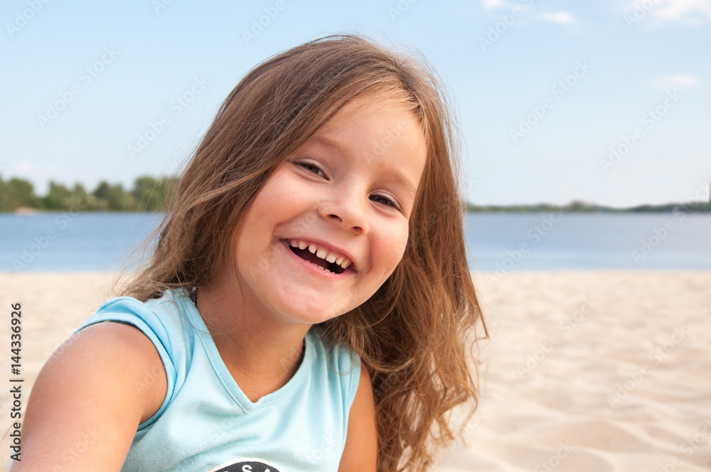 Little girl on the beach, long hair, laughing, happy, portrait, kid, Shore, sand Little girl on the beach, long hair, laughing, happy, portrait, kid, Shore, sand