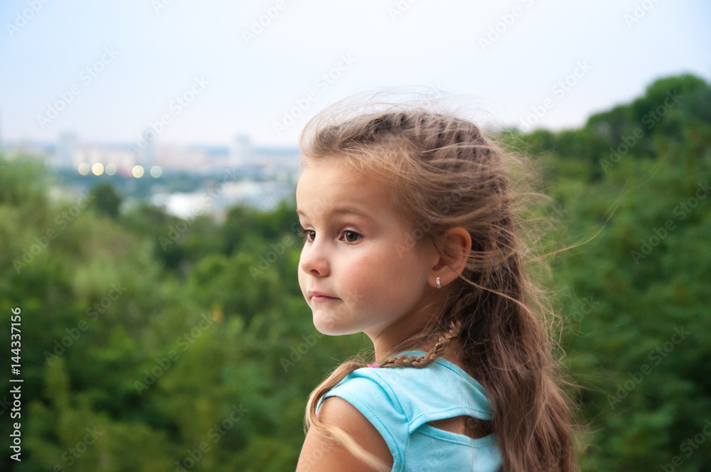 Little girl looking into the distance, landscape, height, city, park Little girl looking into the distance, landscape, height, city, park