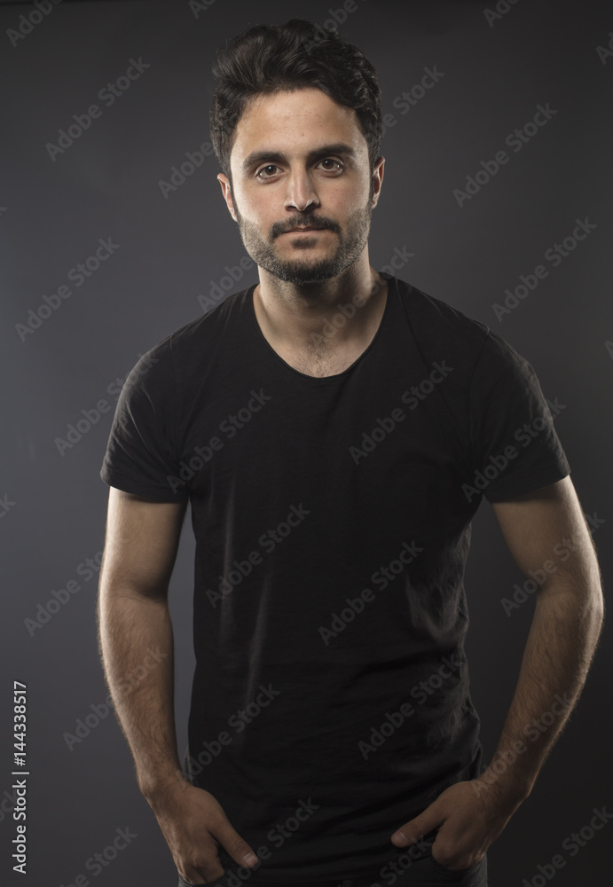 Caucasian guy wearing black T-shirt in studio 