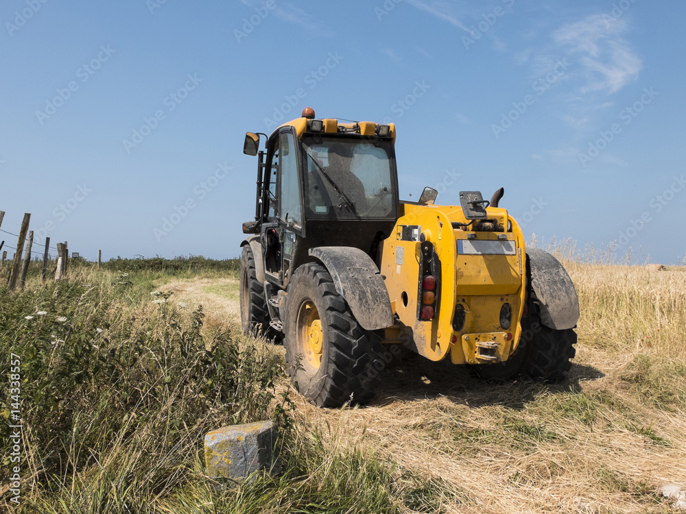 Tractor through a wheat field