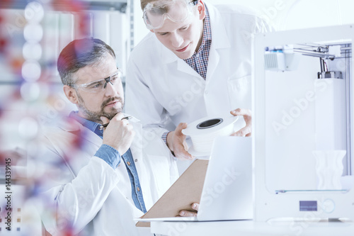 Scientists conferring in laboratory