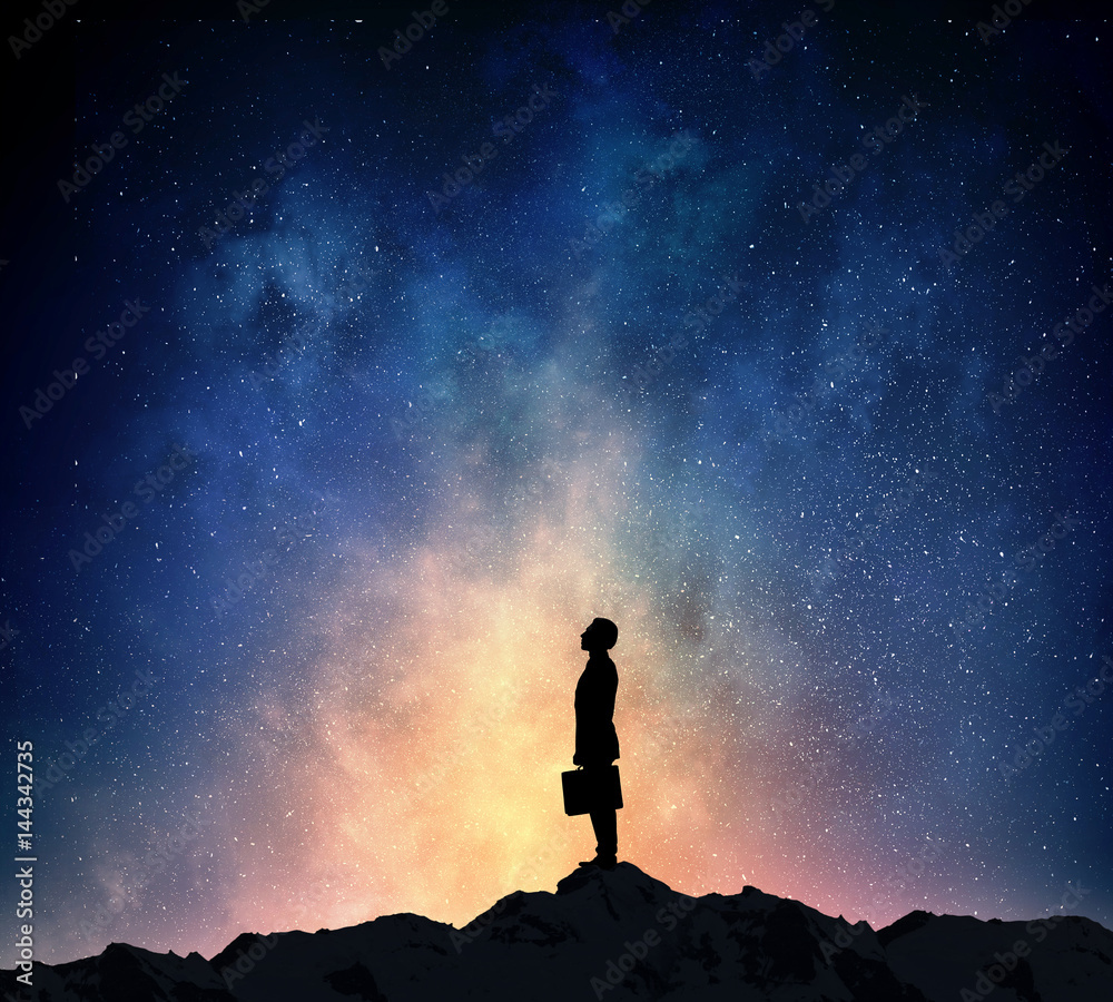 Businessman against starry sky . Mixed media . Mixed media
